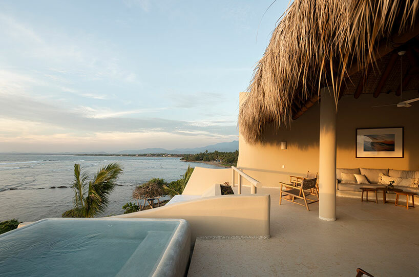 sustainable coastal housing in mexico welcomes surfers to its fluid form