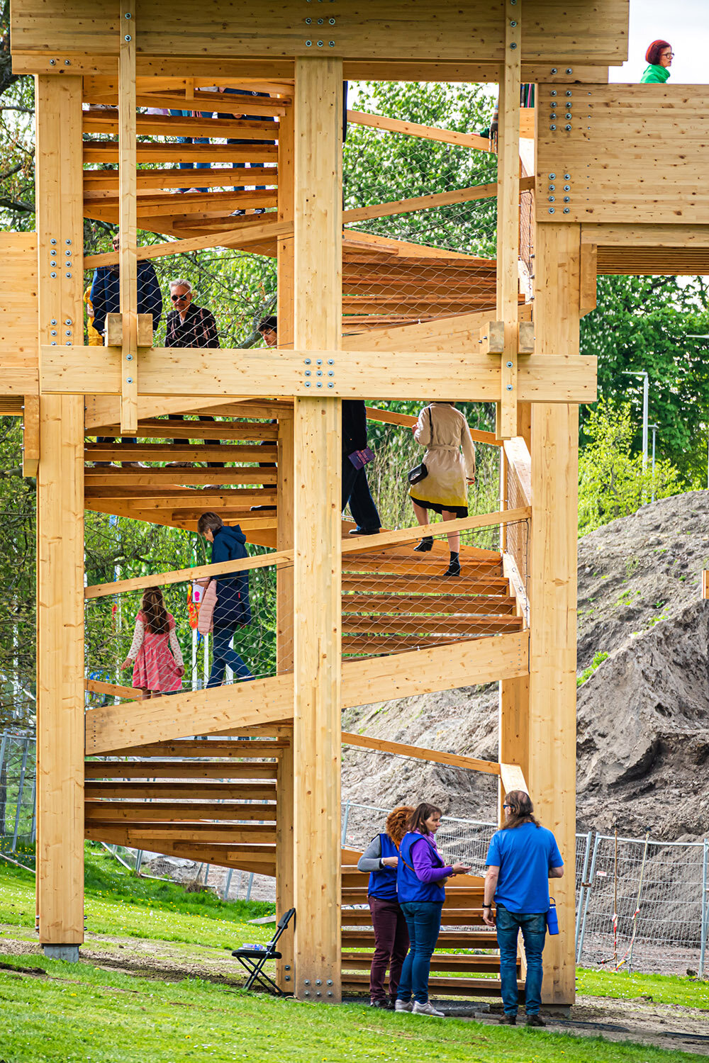 wooden 'tower of balance' by boonserm premthada emits ancient bell sounds across bruges