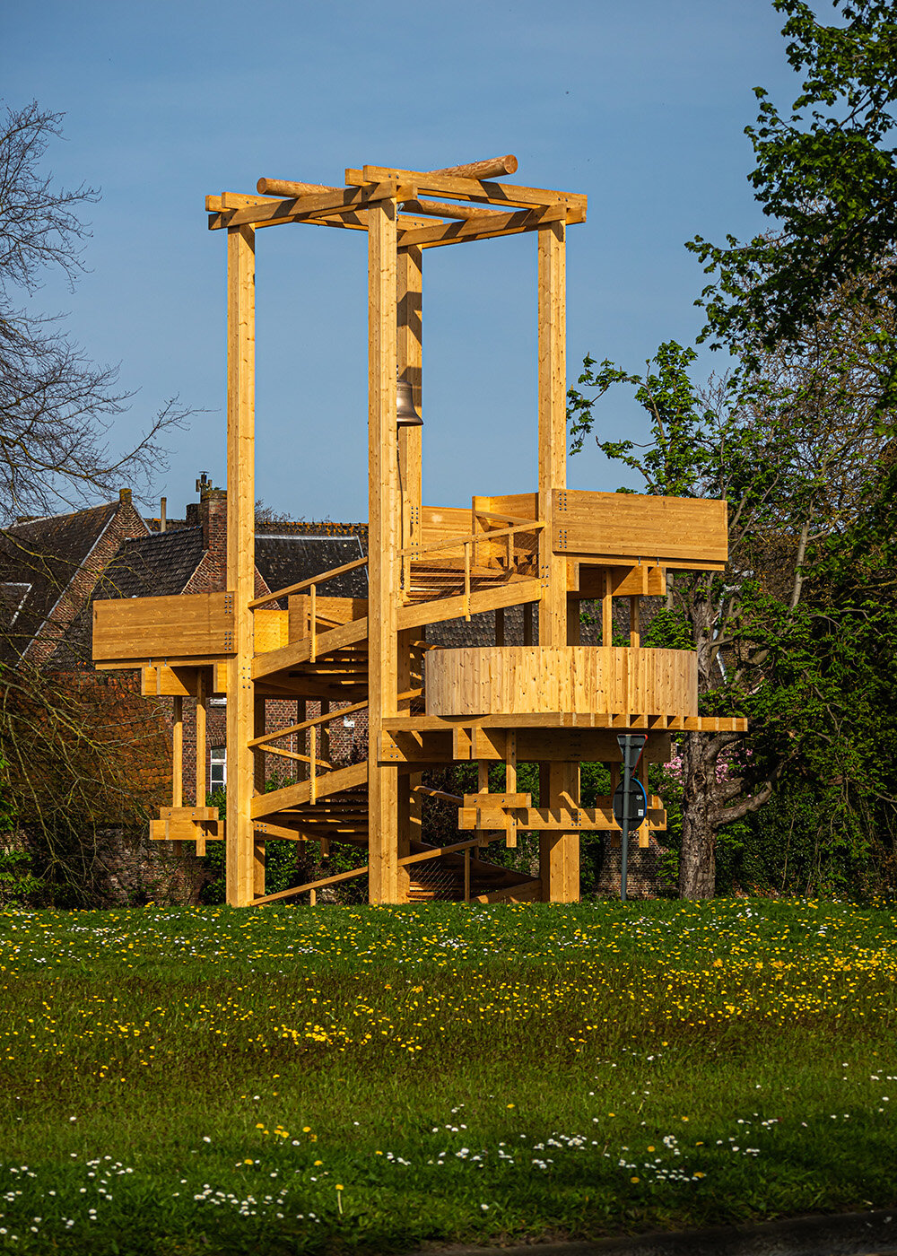 wooden 'tower of balance' by boonserm premthada emits ancient bell sounds across bruges