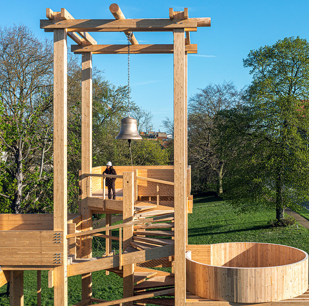 wooden 'tower of balance' by boonserm premthada emits ancient bell sounds across bruges