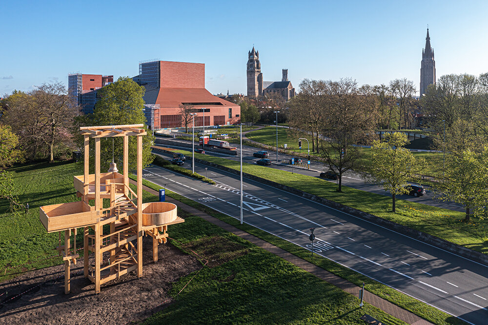 wooden 'tower of balance' by boonserm premthada emits ancient bell sounds across bruges