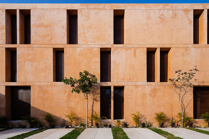 chukum, stone, and rhythmic openings shape mexican housing complex by P11 arquitectos