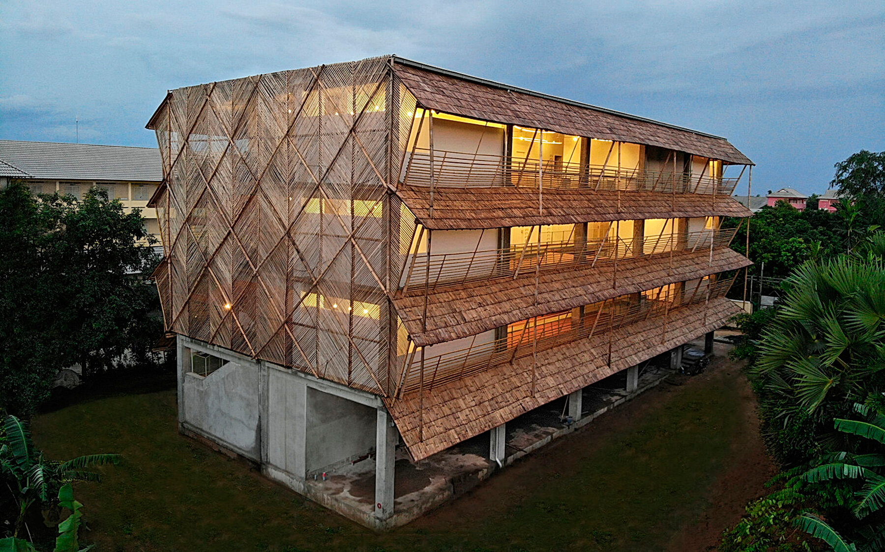 BLOOM screens girl dormitory's concrete skeleton with woven bamboo skin