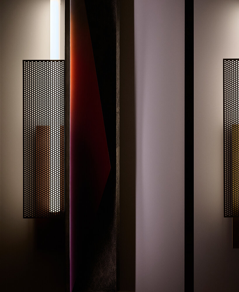 colorful mirrored wall lamp by tarek dada casts transformative reflections