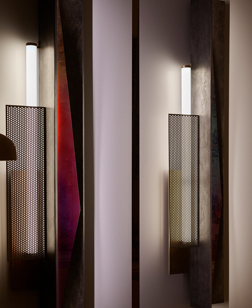 colorful mirrored wall lamp by tarek dada casts transformative reflections
