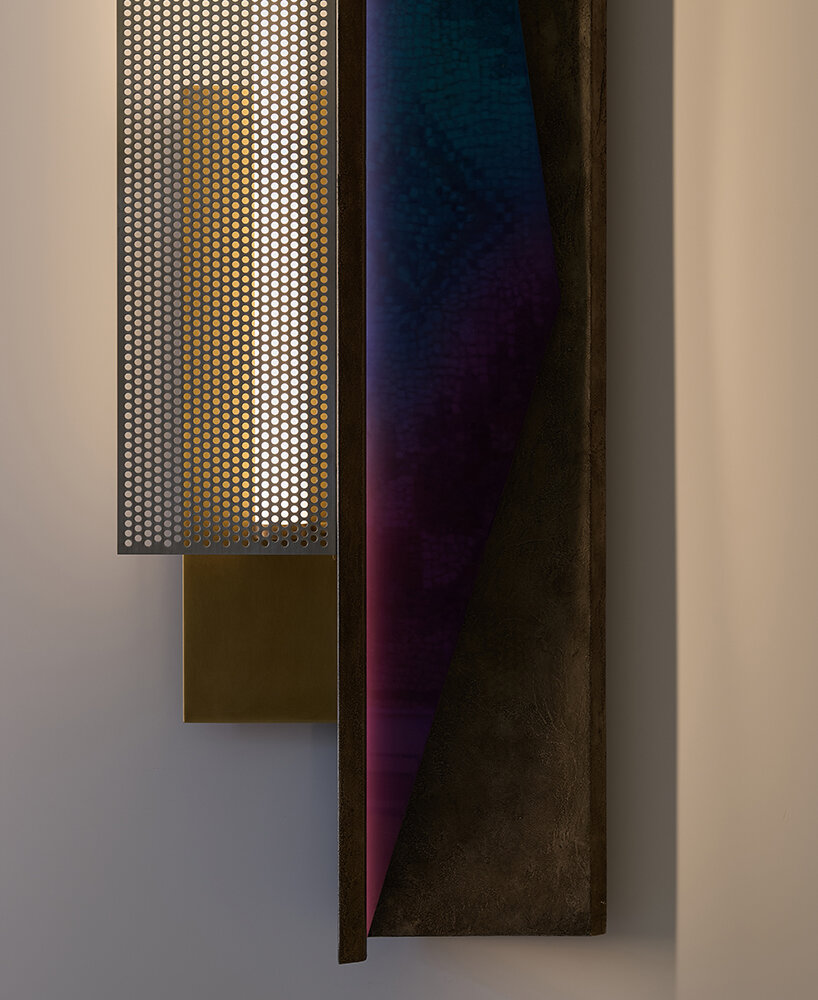 colorful mirrored wall lamp by tarek dada casts transformative reflections