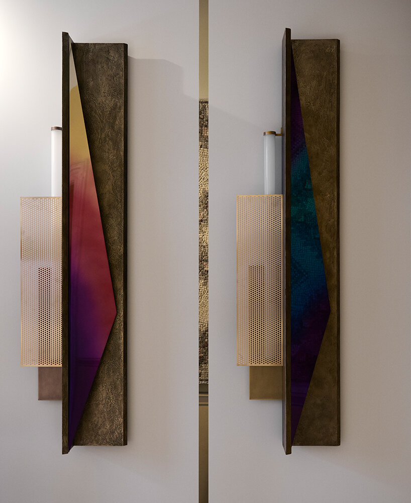 colorful mirrored wall lamp by tarek dada casts transformative reflections