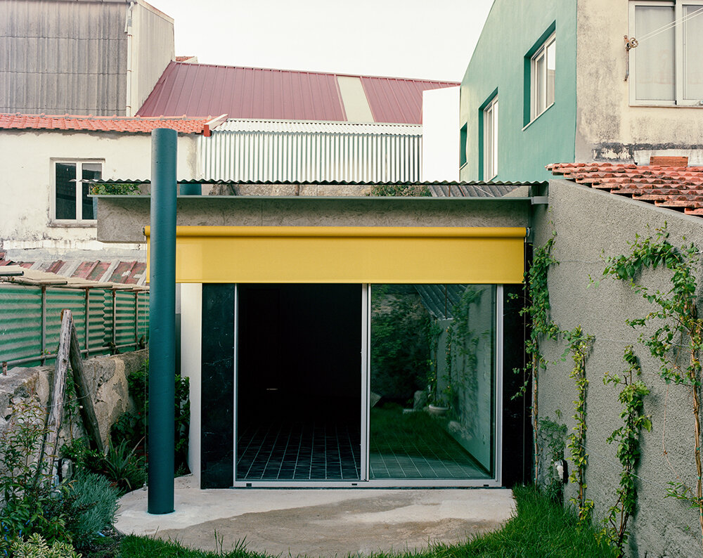 behind a modest front, fala atelier's narrow porto house reveals surprising depth and curves