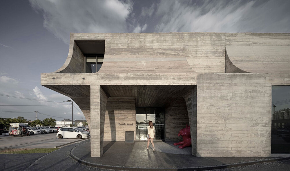cathedral-like concrete arches punctuate TOUCH architect's french kitsch III café in thailand