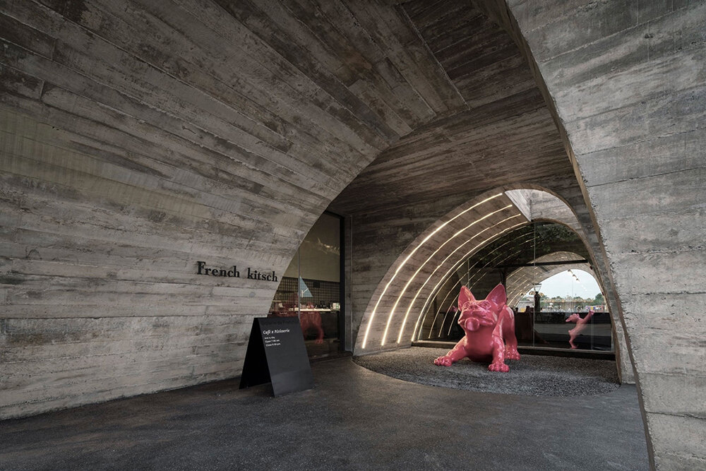 cathedral-like concrete arches punctuate TOUCH architect's french kitsch III café in thailand