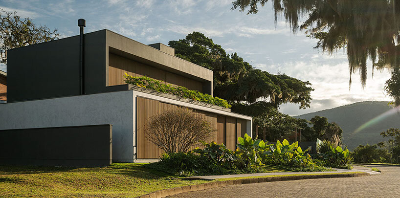 Biombos corredizos de madera enmarcan el amanecer brasileño en una casa familiar diseñada por Studio Bloco