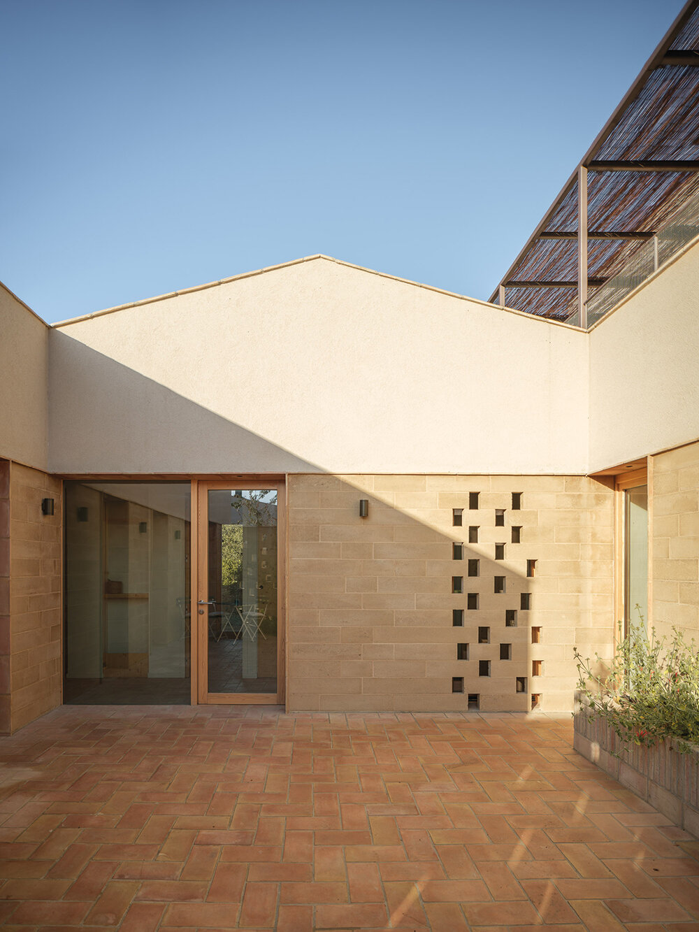 set in spain, nordest arquitectura's passive houses 1922 combine adobe, earth, and wood