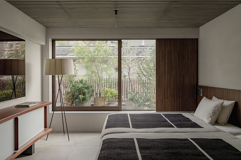 a timber screen facade shelters this house in aoyama, tokyo by keiji ashizawa