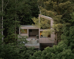 _naturehumaine's pine-wrapped chalet peaks through treetops of canadian woodlands
