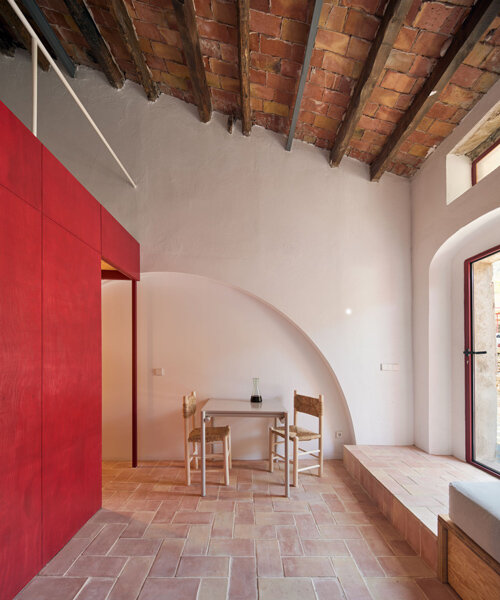 mas estela: rai pinto studio transforms catalan winery into red-infused holiday home