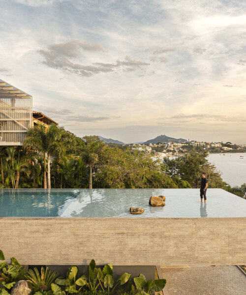 with a suspended infinity pool, tetro's ponte house hangs from the hillside on brazilian island