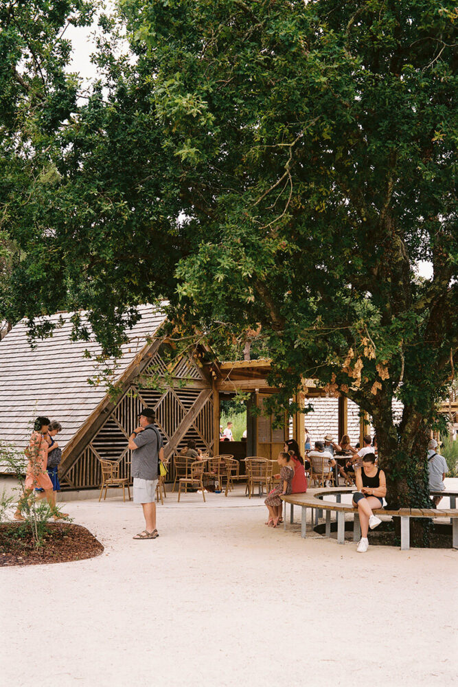 patterned repurposed timber panels clad grande dune du pilat visitor center's huts in france