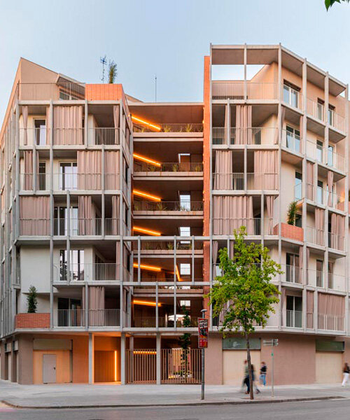 multi-level residential corner building in barcelona boasts open green courtyard