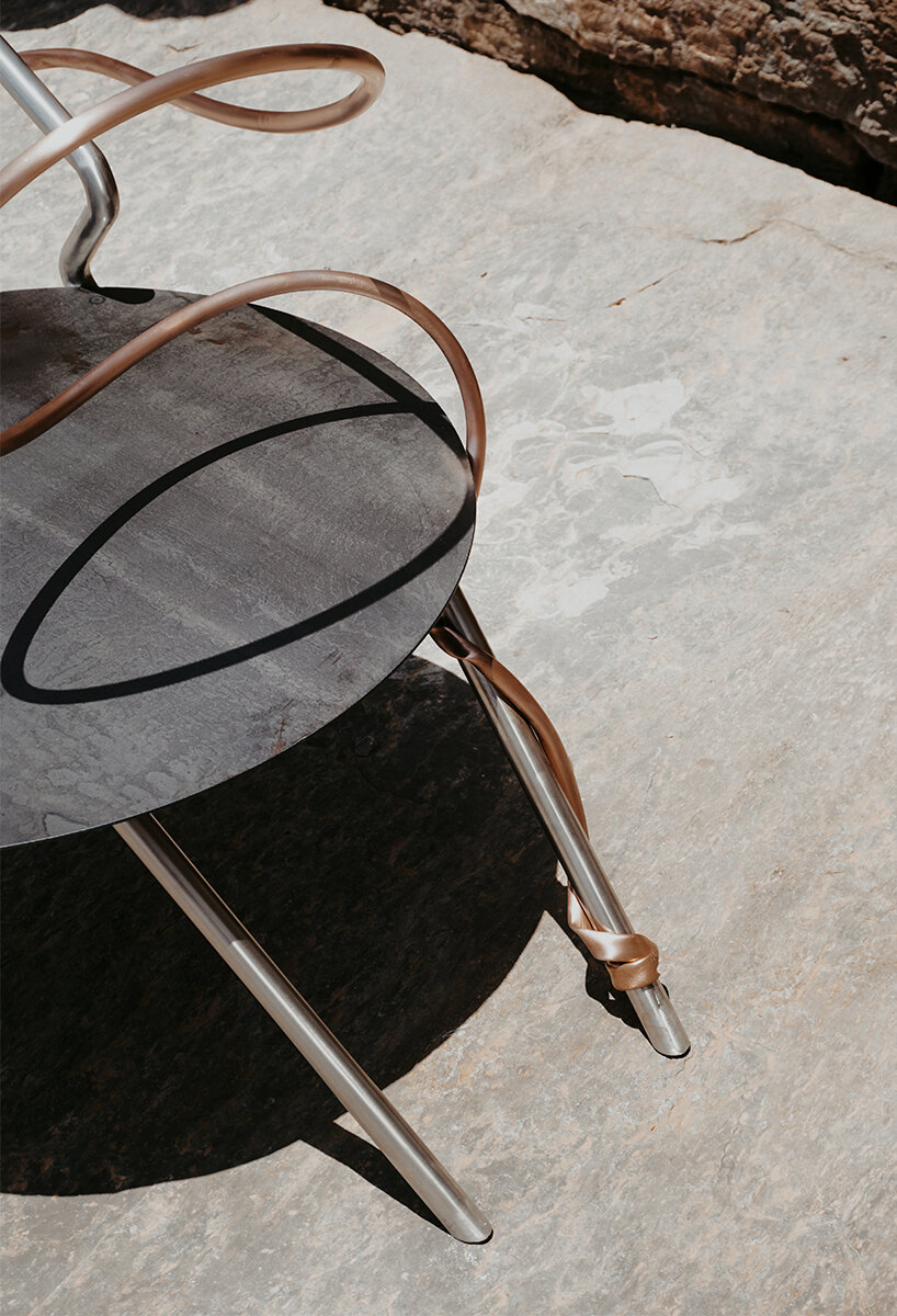 single-stroke cu.01 chair rethinks seating through metallic textures and intersecting forms