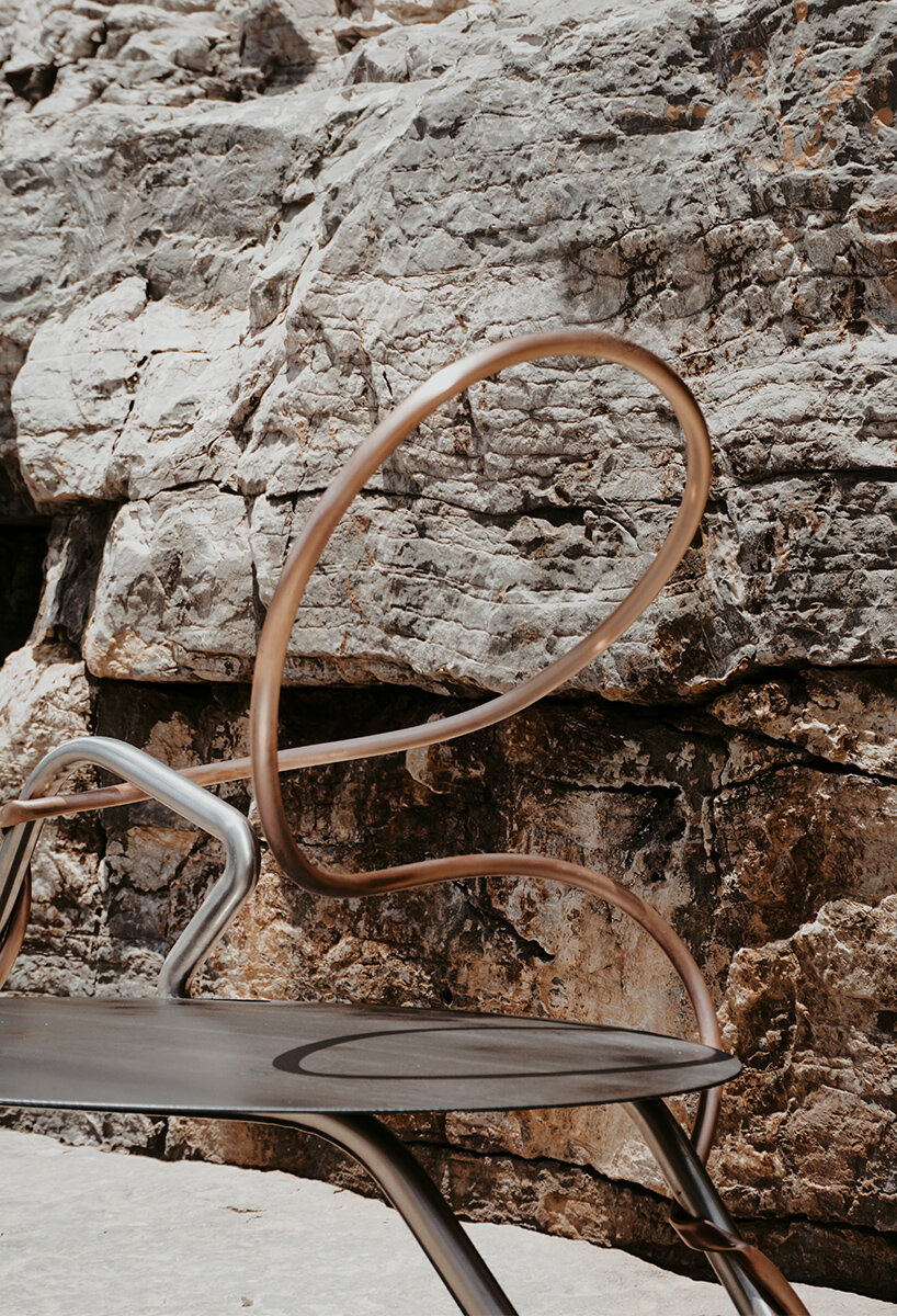 single-stroke cu.01 chair rethinks seating through metallic textures and intersecting forms