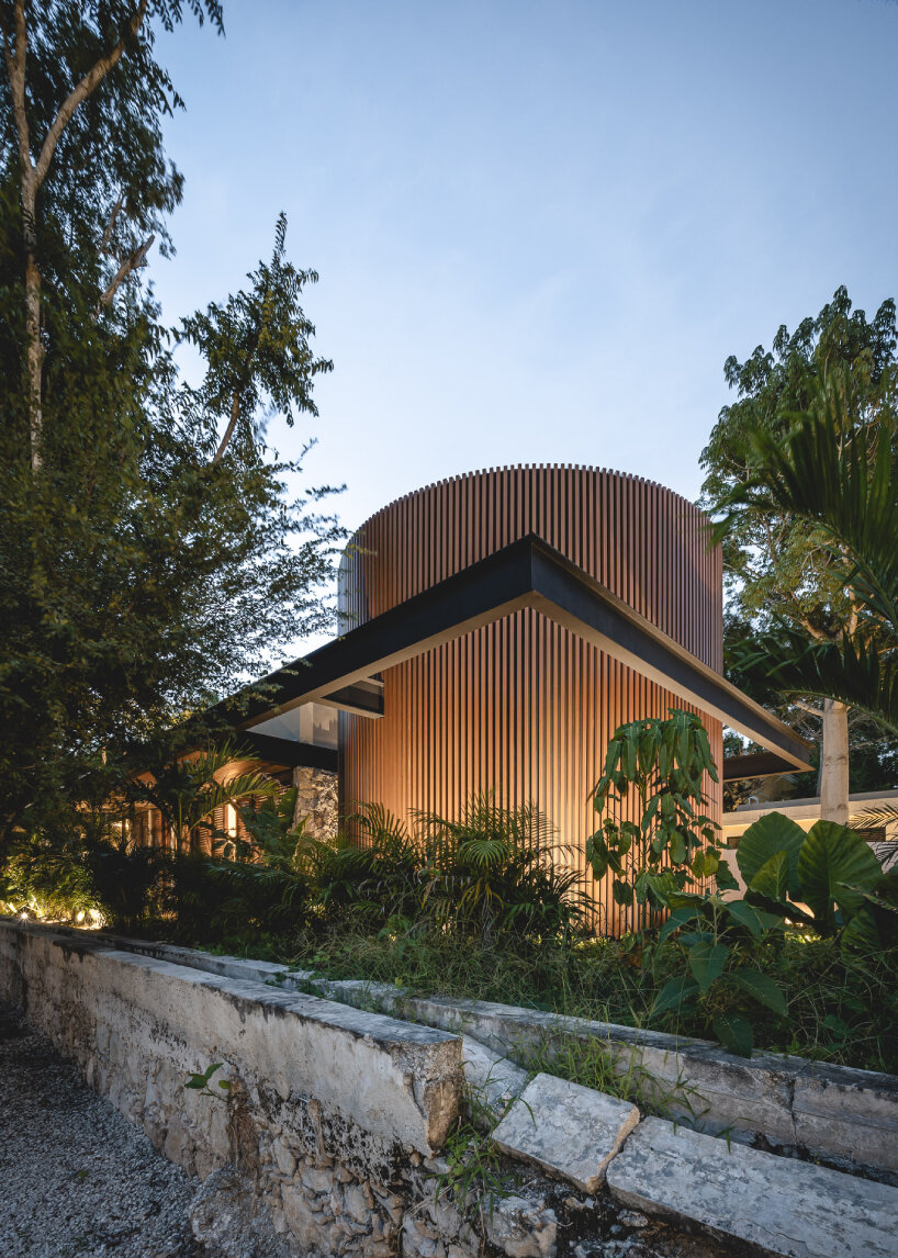 lush vegetation and stone walls enclose taller mexicano de arquitectura's hotel spa in mexico