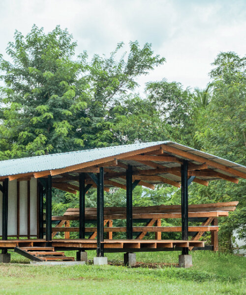 steel and rubberwood pavilion creates open-air learning space in rural thailand school