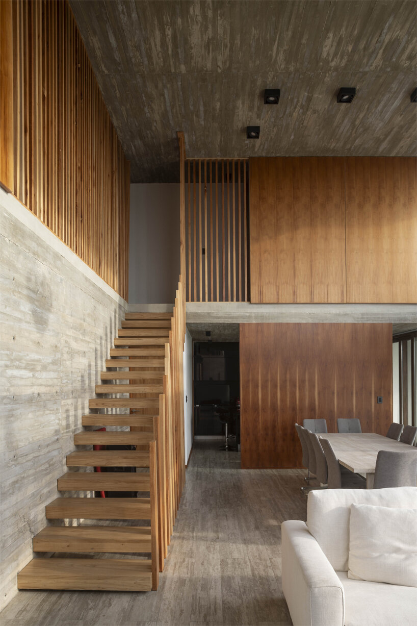 adjustable sunshades animate rustic facade in argentine residence by TIM arquitectos