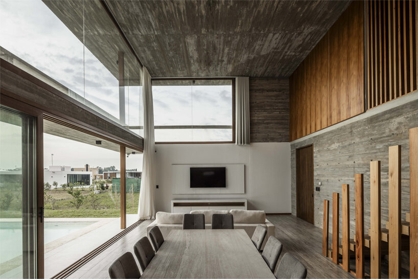 adjustable sunshades animate rustic facade in argentine residence by TIM arquitectos