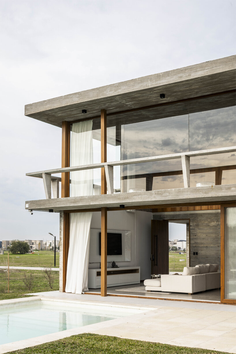 adjustable sunshades animate rustic facade in argentine residence by TIM arquitectos