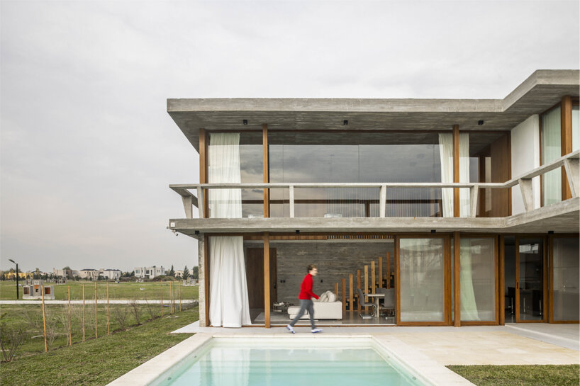 adjustable sunshades animate rustic facade in argentine residence by TIM arquitectos