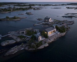 clustered 'whistling wind' cabins by akb architects perch atop tiny canadian island