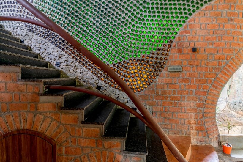 curved brick walls wrap biophilic farmhouse by blurring boundaries in mumbai mangro grove