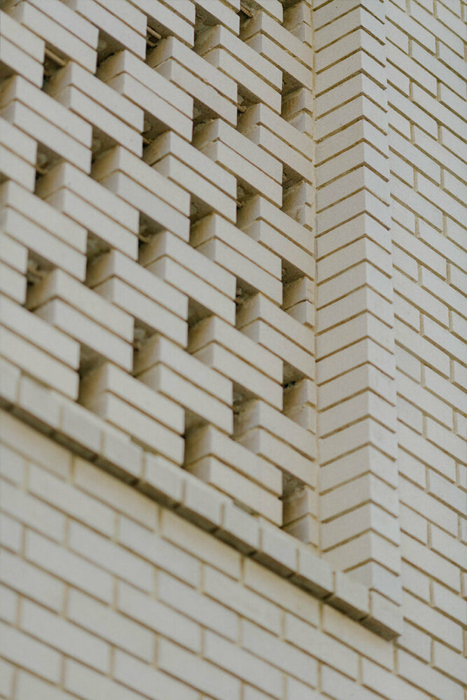 brick-screen facade highlights leica store & gallery in revitalized ...
