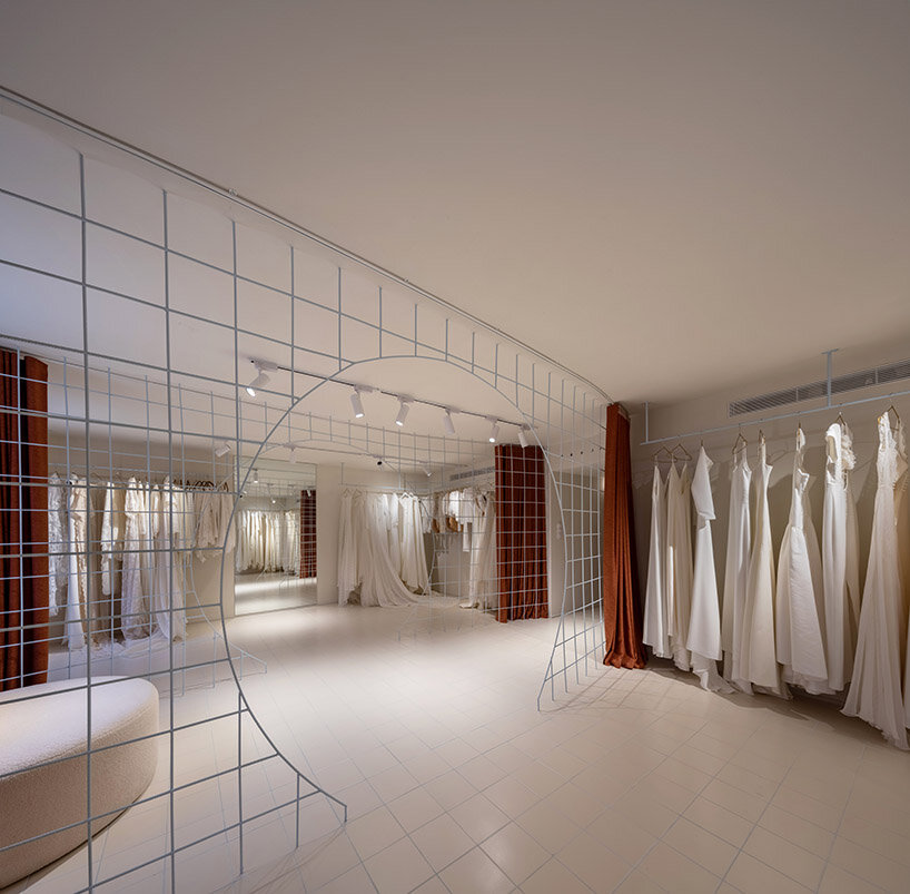 bridal catwalk meets flexible fitting rooms in terracotta-hued spanish store by L'AURA ORTÍN