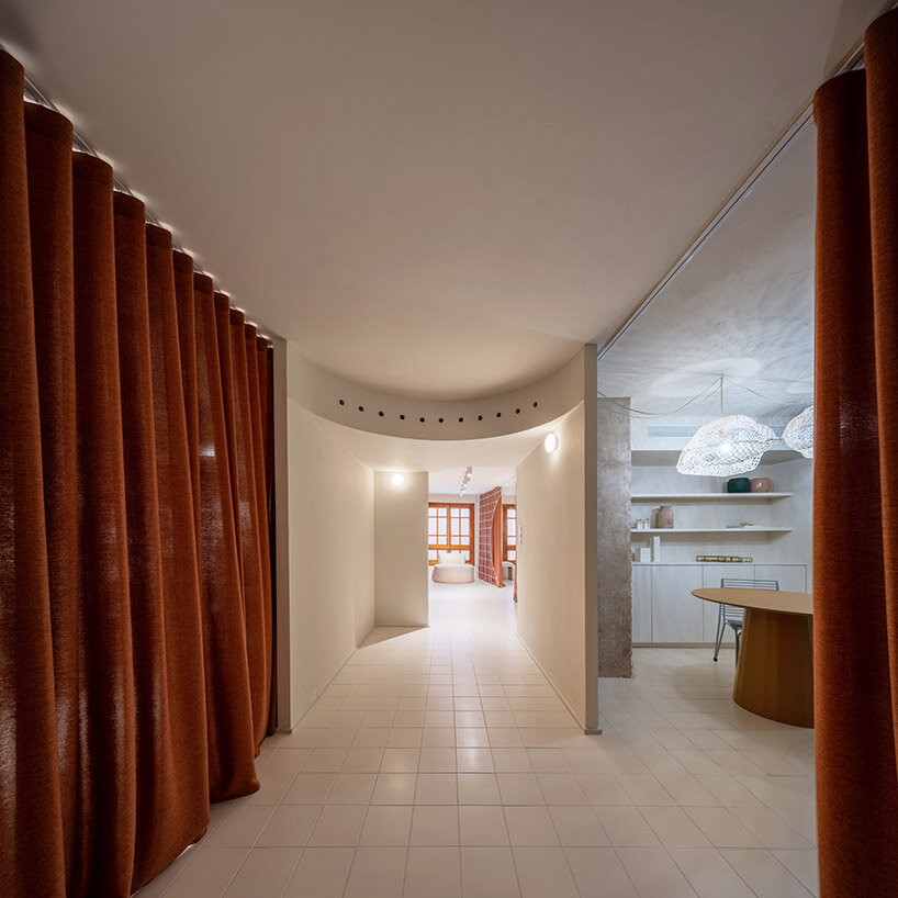 bridal catwalk meets flexible fitting rooms in terracotta-hued spanish store by L'AURA ORTÍN