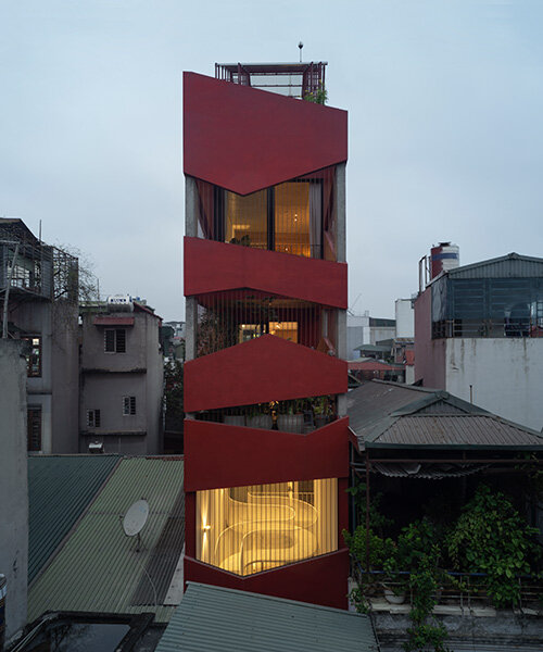 red facade by nghia-architect reflects hanoi’s urban contours through ramdomized patches