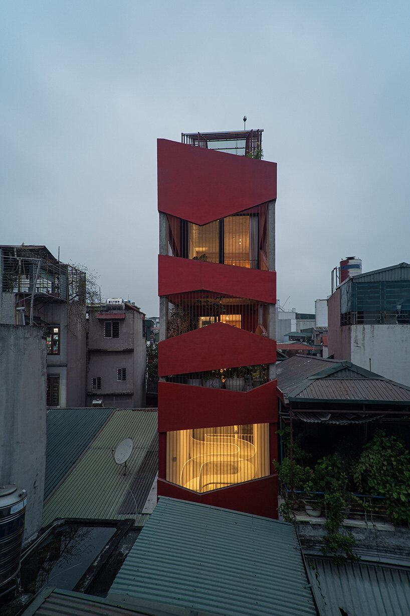 red facade by nghia-architect reflects hanoi’s urban contours through ramdomized patches