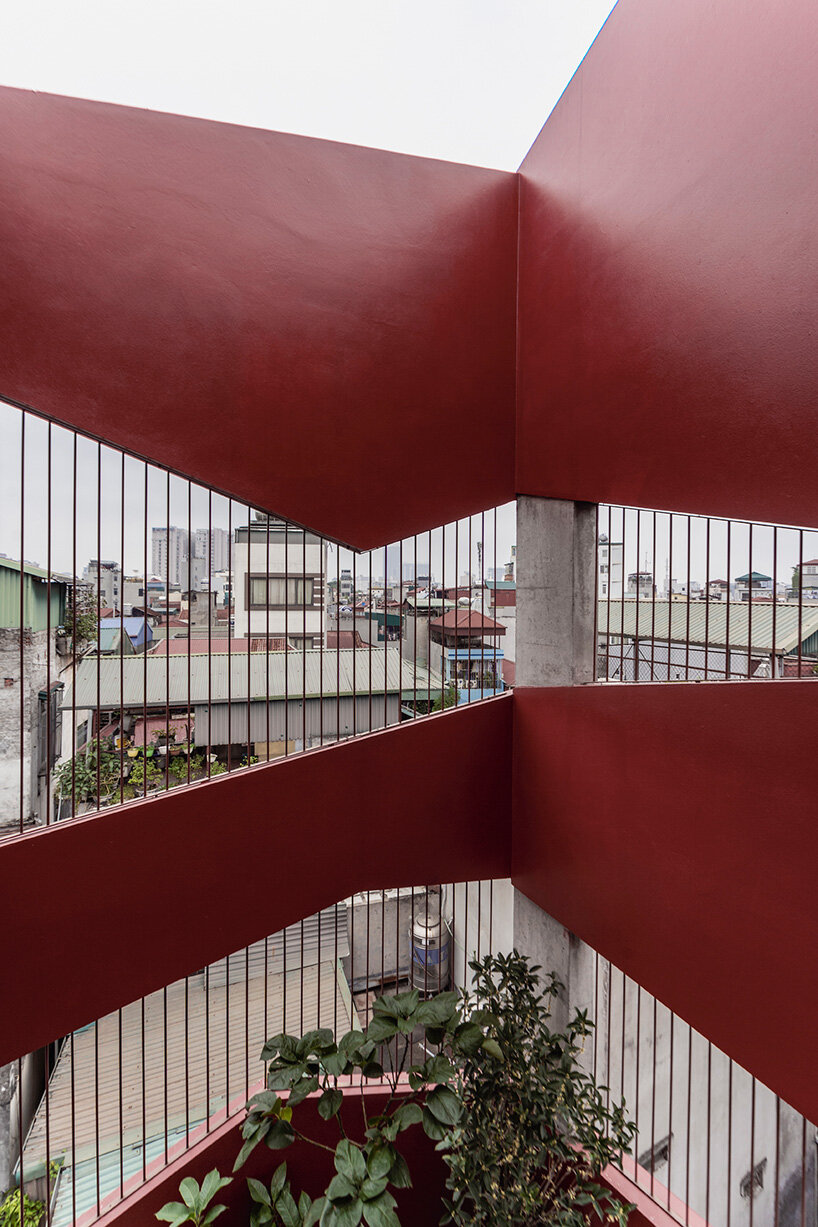red facade by nghia-architect reflects hanoi’s urban contours through ramdomized patches