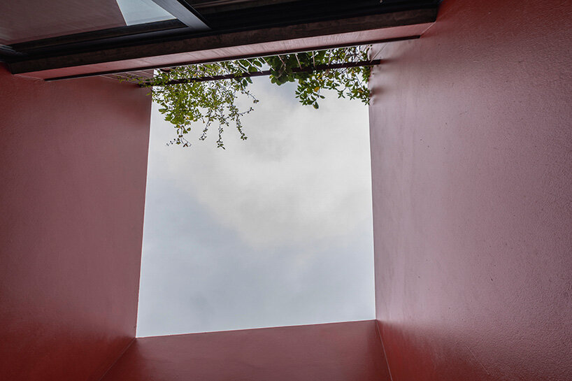 red facade by nghia-architect reflects hanoi’s urban contours through ramdomized patches