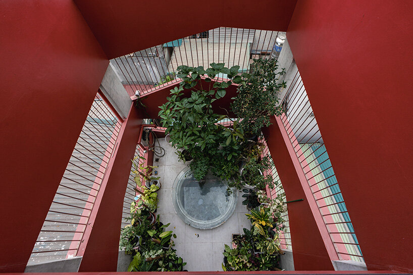 red facade by nghia-architect reflects hanoi’s urban contours through ramdomized patches