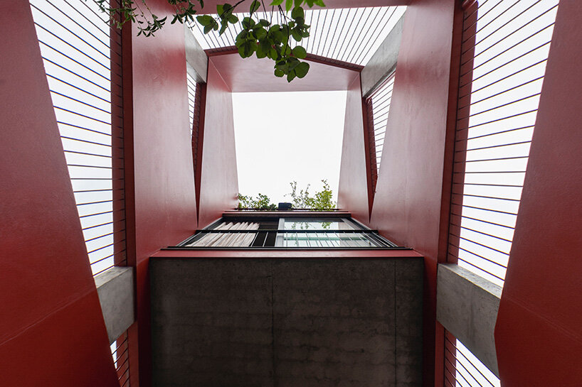 red facade by nghia-architect reflects hanoi’s urban contours through ramdomized patches