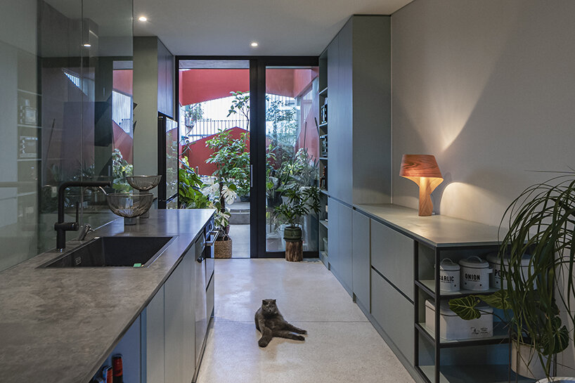 red facade by nghia-architect reflects hanoi’s urban contours through ramdomized patches