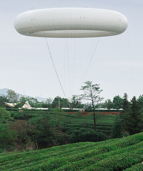 floating cloud-like ring by line+ studio hovers over tea fields in chinese village