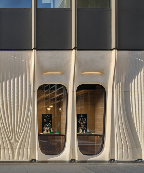 partisans sculpts parametric limestone facade with sinuous arches at toronto rolex boutique