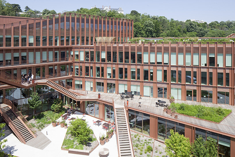 brenac & gonzalez & associés fronts wave-like building with vertical metal slats in france