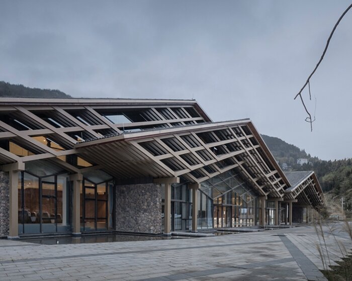 cascading folding roof of GLA design's community center in china echoes mountain contours