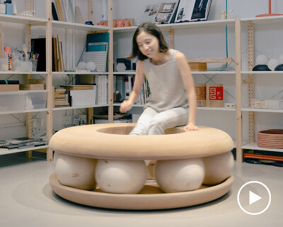 wooden balls set canalside studio's donut-shaped bench into motion