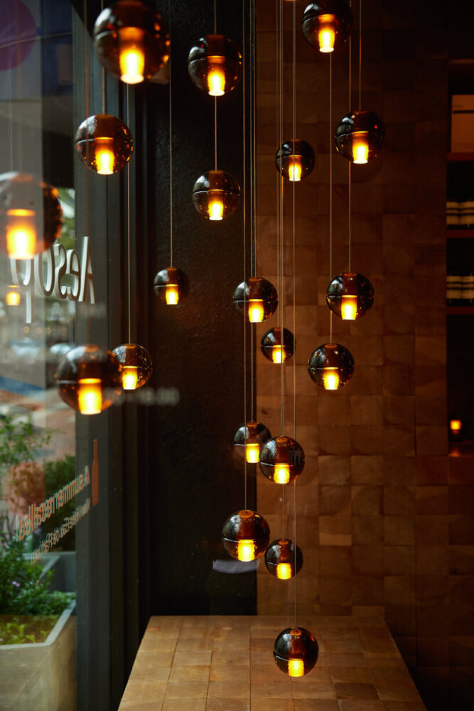 bocci’s rechargeable glass table lights illuminate aesop’s spaces in ...