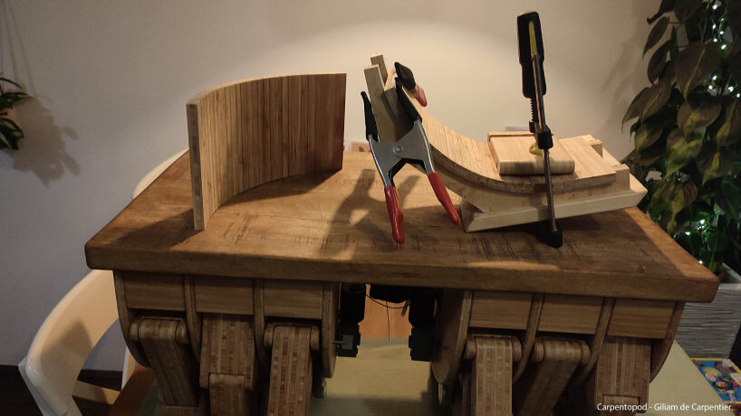 the craftsman uses a three-axis CNC router to make most parts of his walking wooden table, Carpentopod