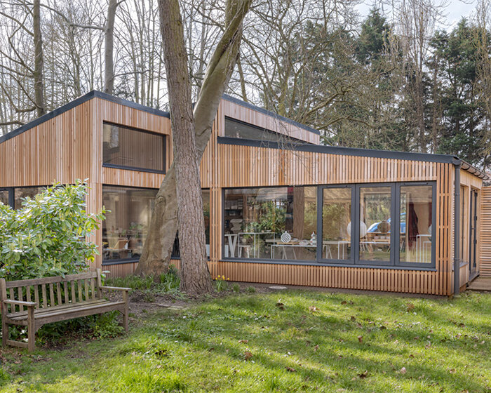 ceramic artist's wood-clad studio extends 80s-built house in the UK
